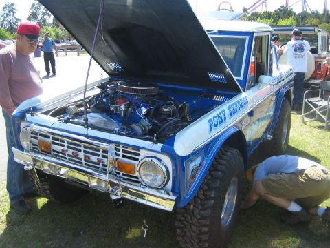 1968 Ford Mustang - A customized Ford Bronco is displayed with its hood up, revealing the engine compartment.