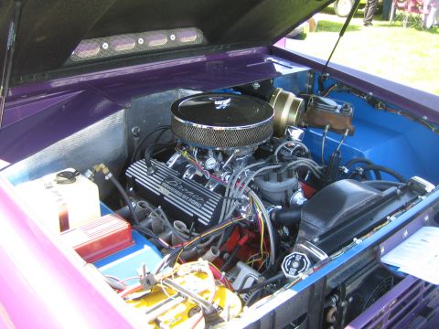 1968 Ford Mustang - The engine bay of a classic vehicle, a V8 engine with chrome accents and custom valve covers.
