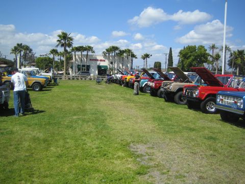 1968 Ford Mustang - A collection of classic Ford Broncos are displayed at an outdoor event under a partly cloudy sky.