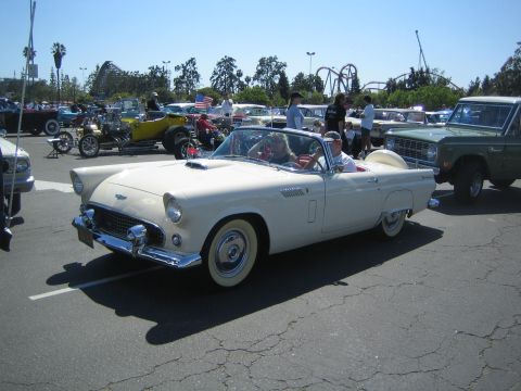 1968 Ford Mustang - A 1956 Ford Thunderbird convertible is parked at a car show with other vehicles.