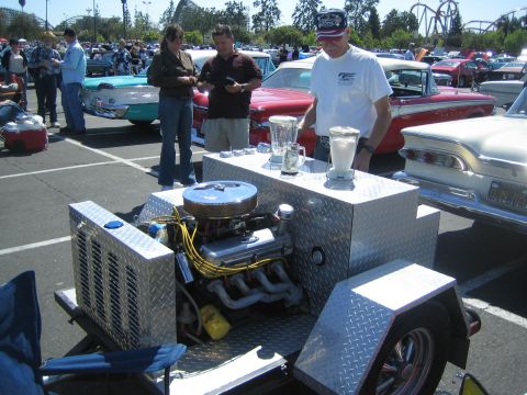 1968 Ford Mustang - A unique trailer a V8 engine and blenders is displayed at a car show event.
