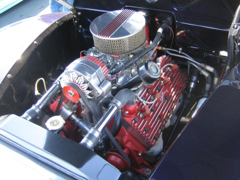 1968 Ford Mustang - Close-up view of a modified engine bay with custom valve covers and air intake system.