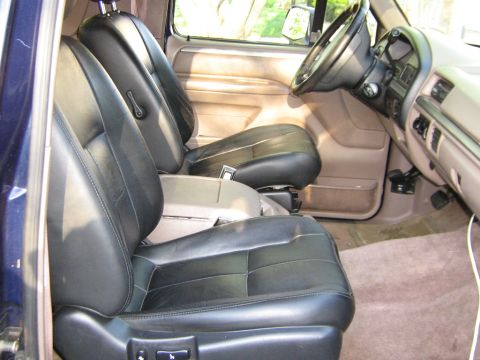 1995 Ford Bronco - Interior view of a 1995 Ford Bronco, highlighting the front seats and dashboard.