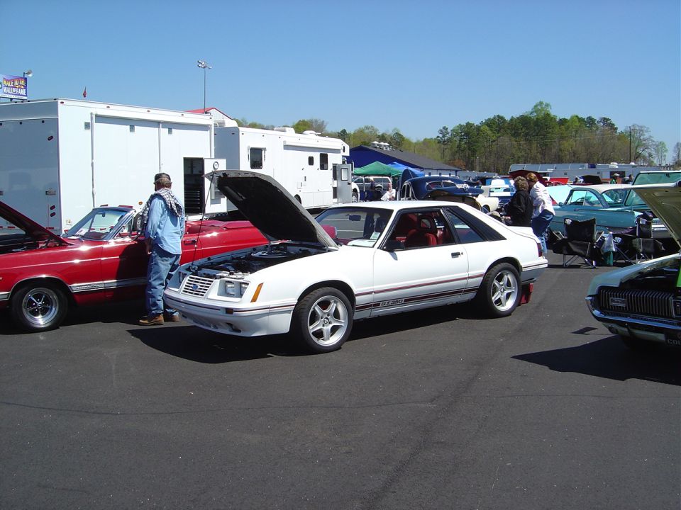 White 1986 Ford Mustang coupe, hood open, side view