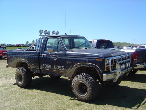 1986 Ford Bronco - This lifted Ford F-150 pickup truck has "BOSS HOSS" graphics on its side and a custom front bumper.