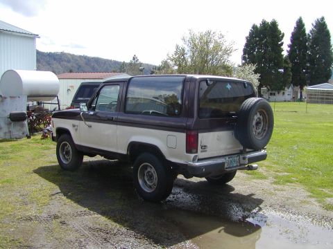 1987 Ford Bronco II - Rear view of a 1987 Ford Bronco II, showing its two-tone paint and spare tire carrier.