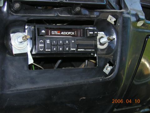 2004 Chevrolet Silverado 3500 - Close-up of an aftermarket Audiovox stereo unit mounted in a vehicle's dashboard.