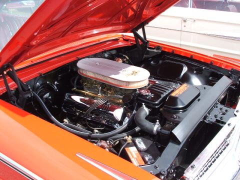 1966 Ford Ranchero - The engine bay of a classic car is shown with a prominent V8 engine and chrome details.