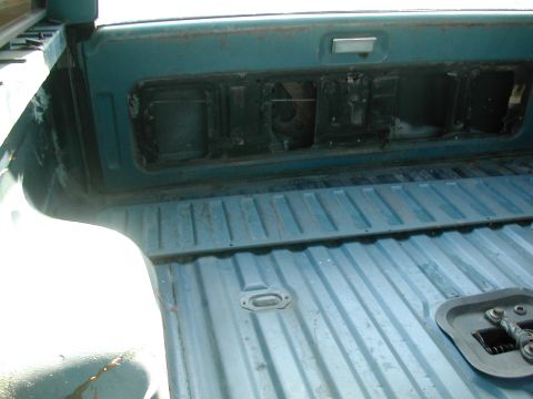 1981 Ford Bronco - The interior of a teal truck bed shows ribbed flooring and a removed tailgate panel, suggesting a utilitarian design.