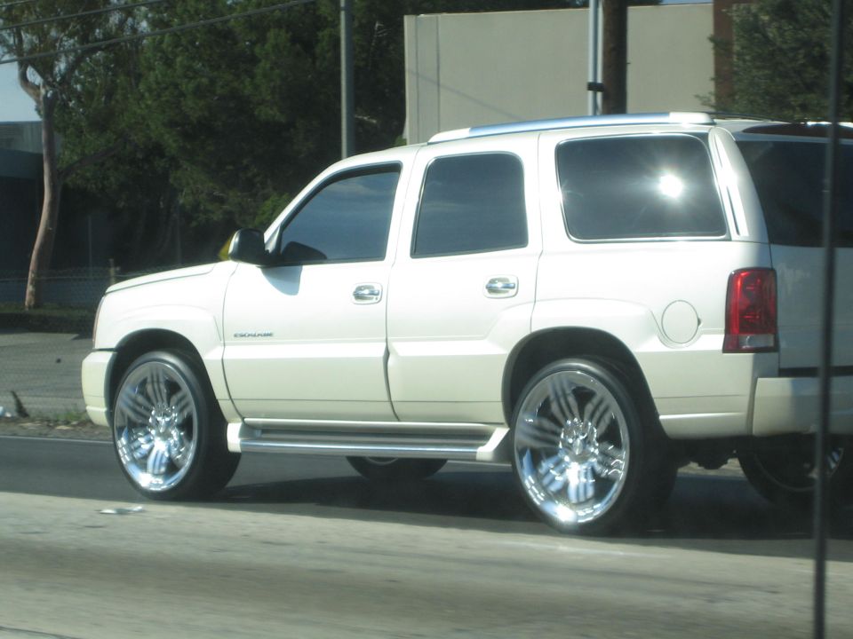 White SUV with chrome rims, side view