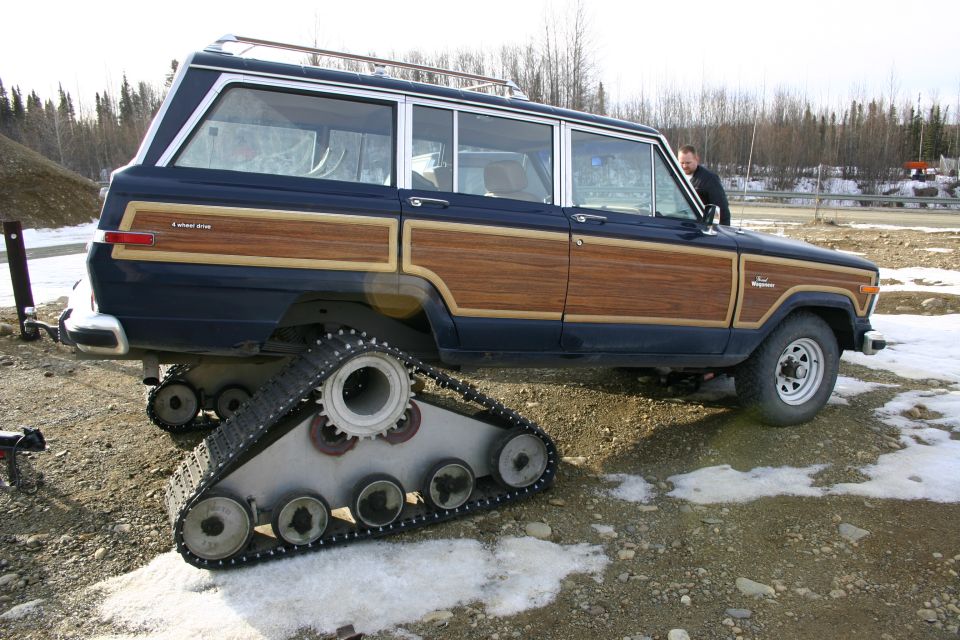 Wood-paneled Jeep Grand Wagoneer with tank tracks instead of wheels