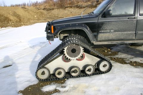 2003 Jeep TJ - Jeep Cherokee modified with snow tracks for off-road travel in winter conditions.