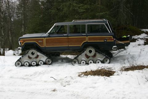 2003 Jeep TJ - This modified Jeep Grand Wagoneer features tank tracks for off-road capability in snowy conditions.