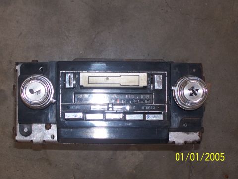 2004 Chevrolet Silverado 3500 - This car stereo features a tape deck and AM/FM radio tuner, with visible tuning and volume knobs.