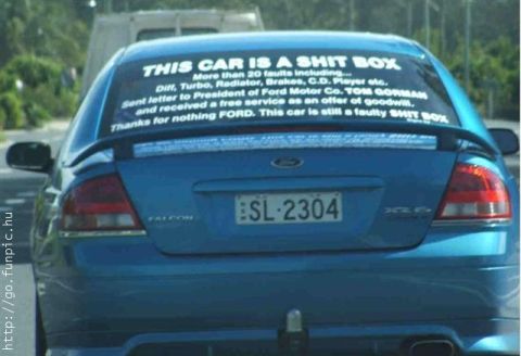 1994 Ford Probe - This car's rear window displays a lengthy complaint about its numerous faults and dissatisfaction with the Ford manufacturer.