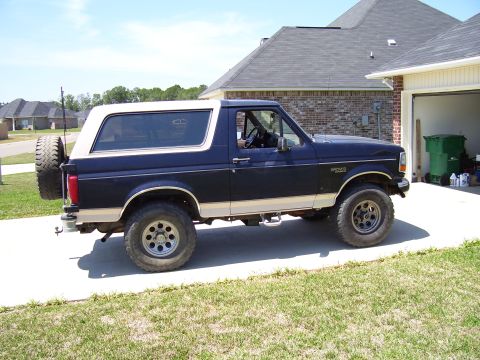 1992 Ford Bronco - This 1992 Ford Bronco is seen from the side, parked in front of a residential garage.