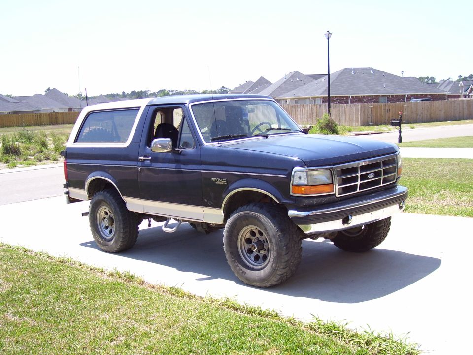 Dark blue 1992 Ford Bronco with white top, 3q front view