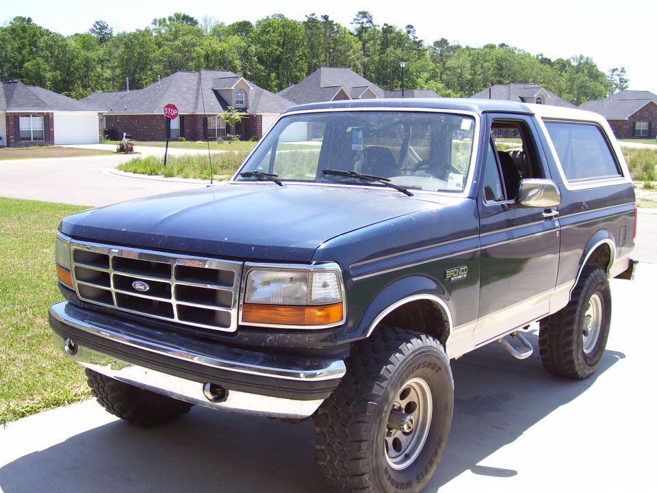 1992 Ford Bronco parked in a suburban driveway, front 3/4 view