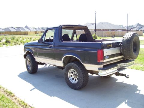1992 Ford Bronco - This 1992 Ford Bronco is viewed from the rear three-quarter angle, showing its two-tone paint scheme and spare tire.