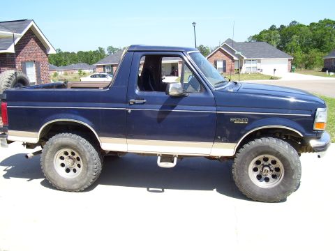 1992 Ford Bronco - This 1992 Ford Bronco is parked on a concrete driveway in front of houses.