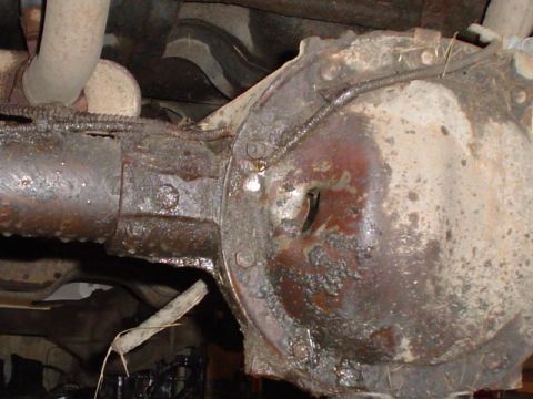 1981 Ford Bronco - Close-up view of a heavily corroded rear differential and exhaust system components.