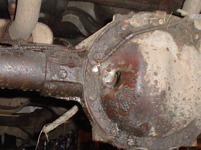 Rusty rear differential and exhaust pipe under a vehicle