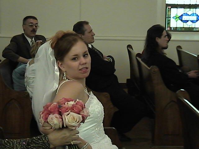 Bride sticking tongue out at wedding ceremony