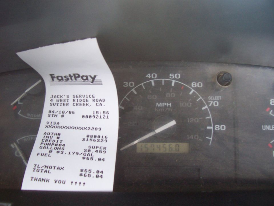 Gas receipt for 20.459 gallons resting on truck dash gauge cluster