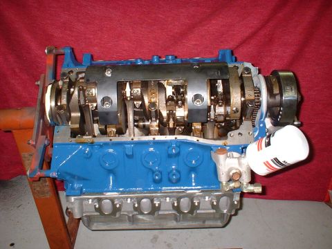 1971 Ford Mustang - Ford V8 engine block assembly with visible crankshaft and oil filter, mounted on a stand.