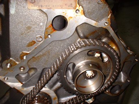 1971 Ford Mustang - A close-up view of an engine's timing chain and gears, showing signs of rust and wear.