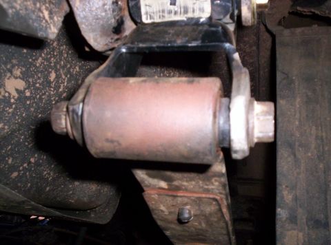 1995 Ford Bronco - This photo shows a close-up view of a vehicle's suspension component, specifically a leaf spring shackle mount.