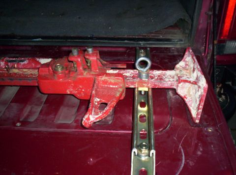 1995 Ford Bronco - Hi-lift jack mounted in the cargo area of a red vehicle.
