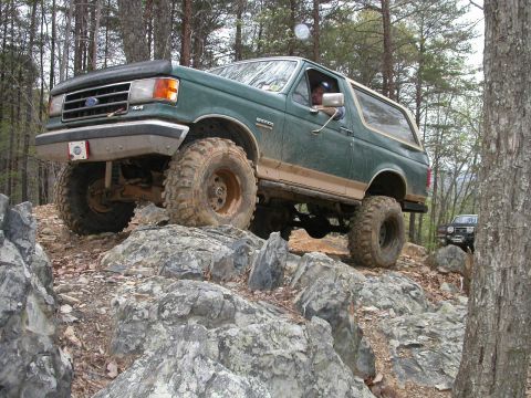 1990 Ford Bronco - Green 1990 Ford Bronco navigates a challenging rocky off-road course.