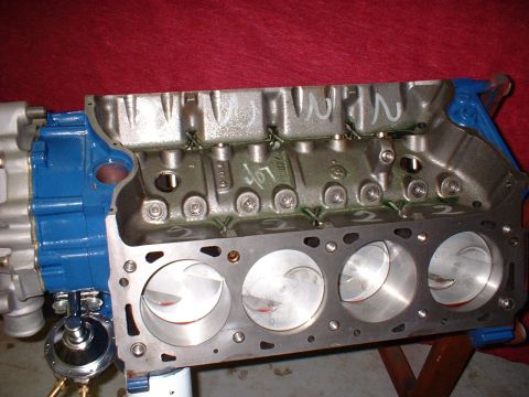 1971 Ford Mustang - A close-up view of an engine block with pistons, showing internal components and some handwritten markings.