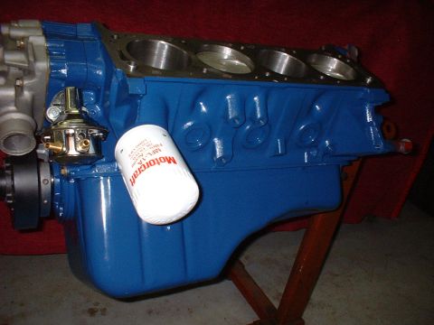 1971 Ford Mustang - A blue engine block is shown with a white oil filter. The engine appears to be a V8.