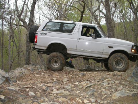 1990 Ford Bronco - This 1990 Ford Bronco is shown off-roading over a challenging rocky path.