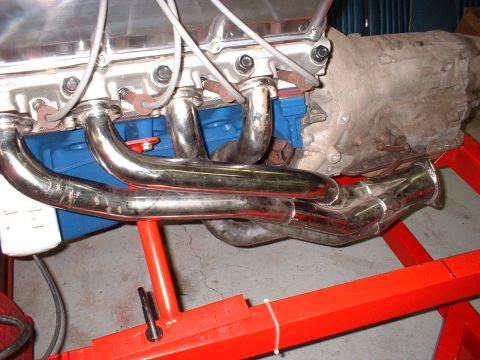 1971 Ford Mustang - Close-up view of an engine and transmission assembly, supported by a red stand.