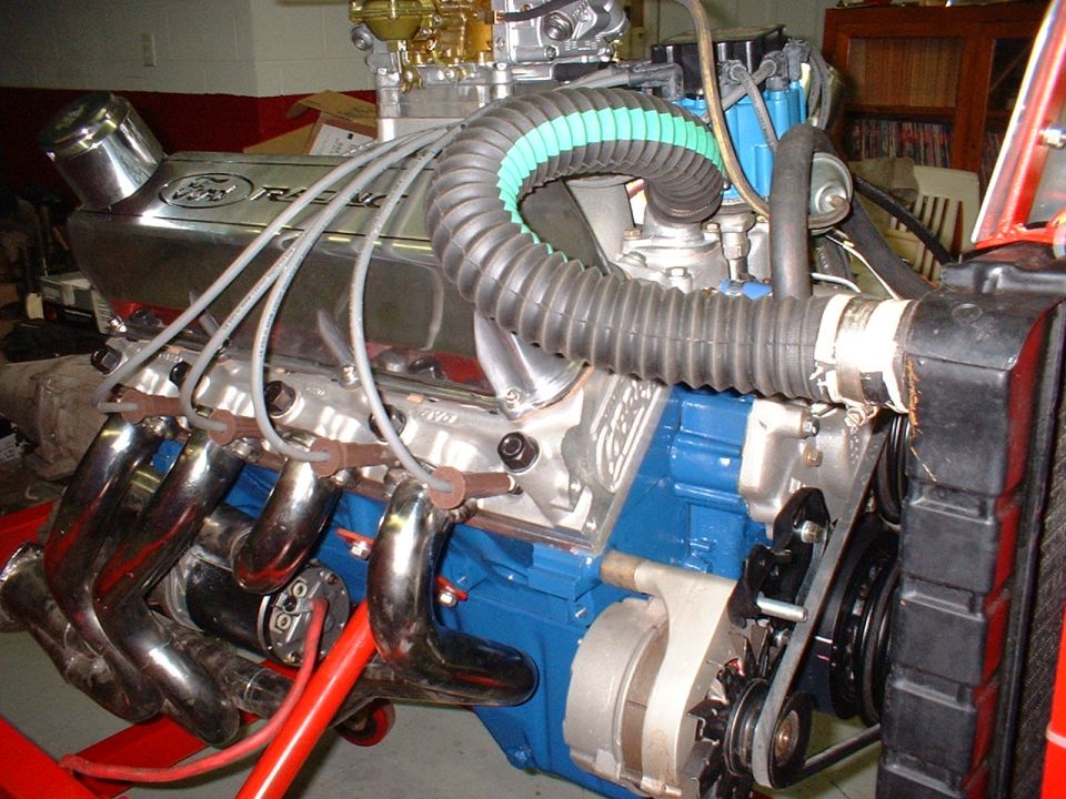 Ford Racing engine with chrome valve covers, headers, and blue block