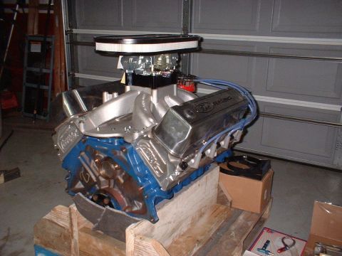 1971 Ford Mustang - A Ford V8 engine, likely a performance build, is shown in a garage setting.