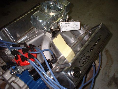 1971 Ford Mustang - Close-up of a Ford V8 engine component with visible 'Ford Racing' branding and a carburetor.