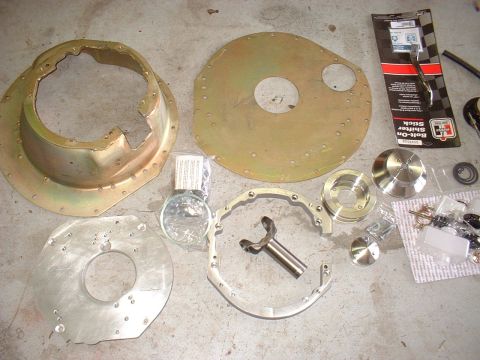1971 Ford Mustang - Various transmission and shifter components are spread out on a concrete surface, ready for installation.