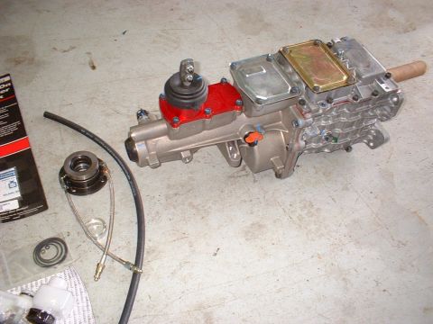 1971 Ford Mustang - Transmission and clutch components laid out on a concrete surface, ready for installation.