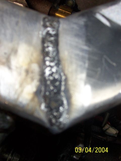 1994 Ford Probe - A close-up view of a welded metal pipe, with a timestamp indicating it was photographed on March 4, 2004.
