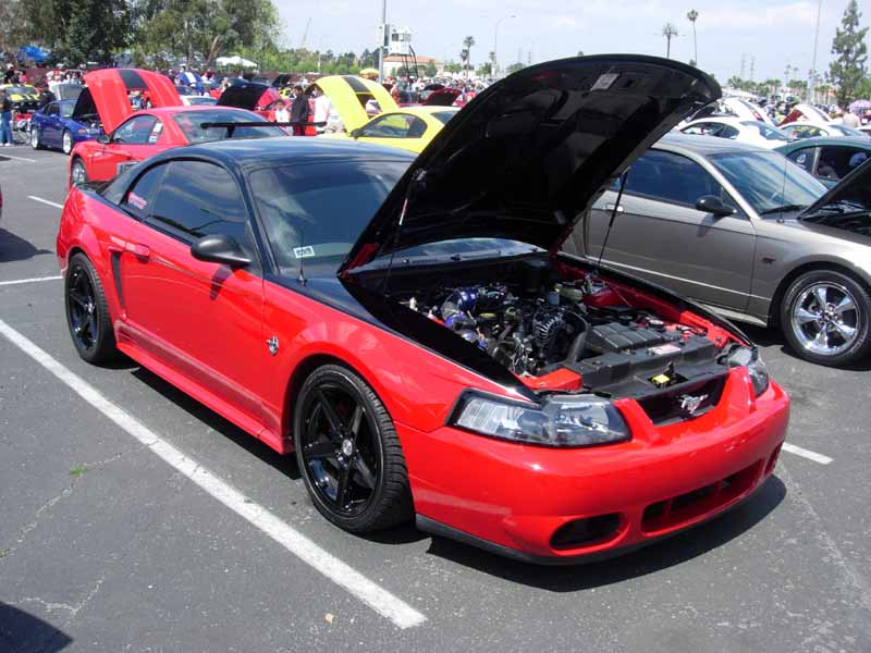 Red New Edge Ford Mustang GT with black wheels and hood up