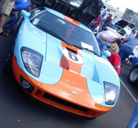 1998 Ford Crown Victoria - Ford GT supercar in light-blue and orange Gulf livery with a number 6 roundel is photographed head-on amid a crowd at a show.