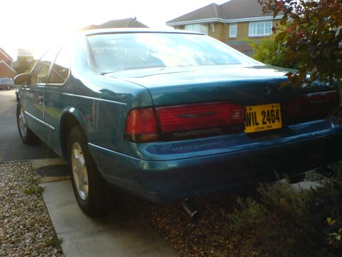 1994 Ford Thunderbird - Rear view of a teal 1994 Ford Thunderbird parked in a driveway.