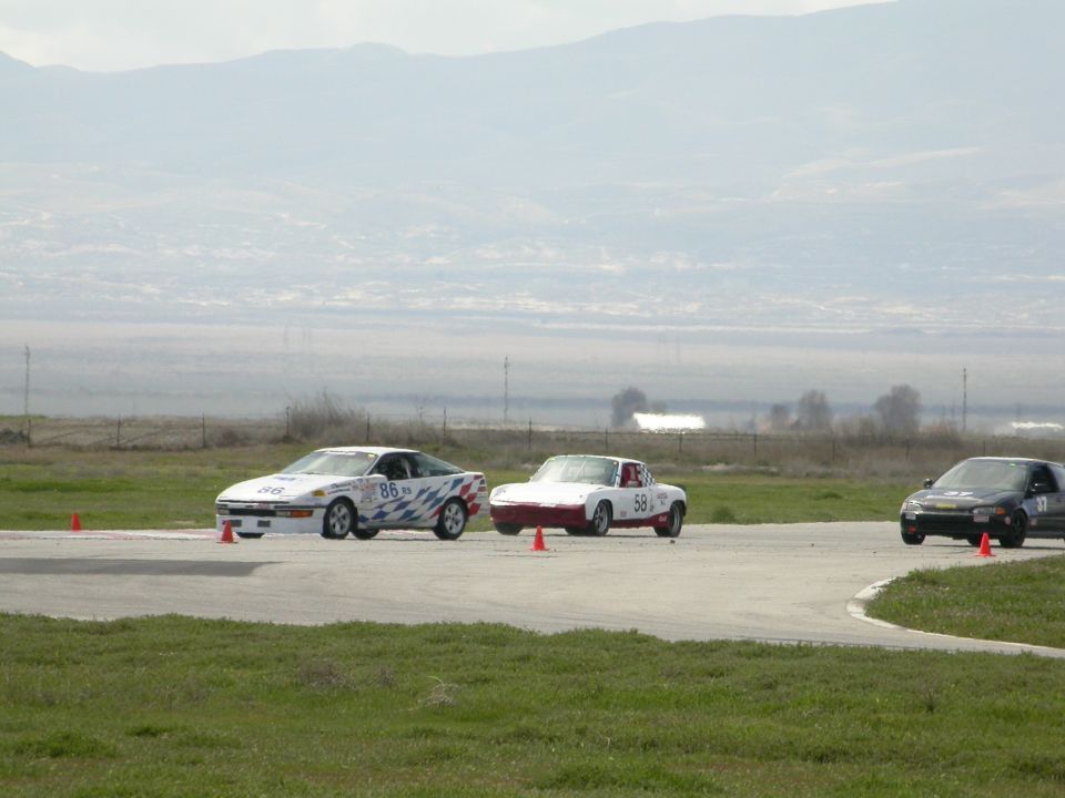 White 1989 Toyota MR2 with red and blue graphics on a race track