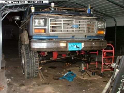 1985 Ford Bronco - This Ford truck appears to be from the early 1980s, possibly a Bronco or F-series, undergoing maintenance in a garage.