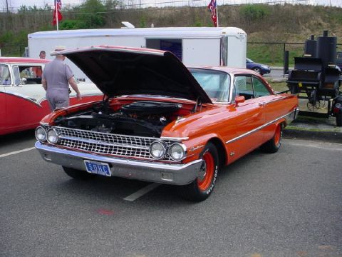 1972 Ford Ranchero - An orange classic car is parked with its hood up, revealing the engine bay.