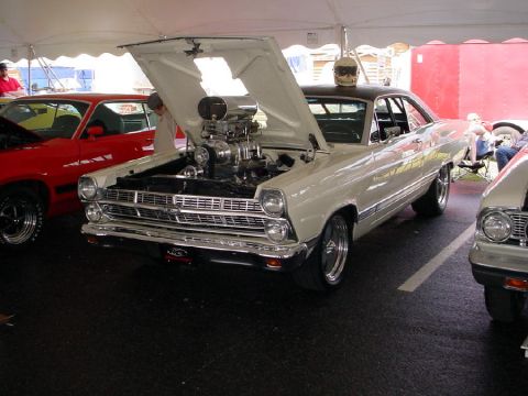 1972 Ford Ranchero - A cream 1966 Ford Fairlane, modified with a supercharged engine and drag racing tires, is displayed with its hood open.
